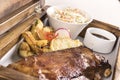 Fancy dish with grilled pork ribs, barbecue sauce, French fries, Coleslaw salad, in a wooden box Royalty Free Stock Photo