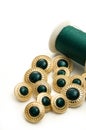 Fancy Green and Gold Sewing Buttons with Green Thread Royalty Free Stock Photo