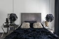 Grey, black and white bedroom interior with king size bed