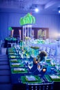 Fancy guest long table set up for a wedding or social event in the ballroom orchid and lucite center piece green Royalty Free Stock Photo