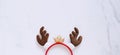 Fancy headband with reindeer antler decorative shape for christmas party and celebration on white marble background