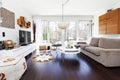 Fancy living room with large window and dark wooden floor Royalty Free Stock Photo