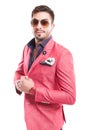 Fancy male model wearing sunglasses and pink elegant jacket