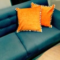 Fancy orange cushions decorating a sofa
