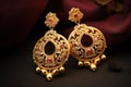 fancy pair of earrings with intricate design and sparkling accents