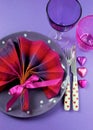 Fancy pink and purple table setting with fan shape napkin - vertical. Royalty Free Stock Photo