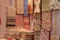 Fancy sarees / unstitched suits hanging and folded on display in a Swadeshi khadi handloom exhibition at Dilli Haat, New Delhi,