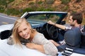 Fancy some adventure. a young couple enjoying a drive in a convertible.