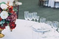 Fancy table set for dinner with flower composition in restaurant, luxury interior background. Wedding elegant banquet Royalty Free Stock Photo