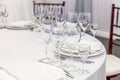 Fancy table set for dinner with napkin glasses in restaurant, luxury interior background. Wedding elegant banquet decoration and Royalty Free Stock Photo