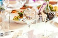 Fancy table set for dinner with napkin glasses in restaurant, luxury interior background. Wedding elegant banquet Royalty Free Stock Photo