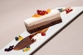 Fancy triple mousse chocolate dessert, decorated with forest fruits and chocolate sauce