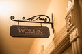 Fancy womens bathroom sign hanging above door Royalty Free Stock Photo