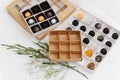 Fancy wrapped chocolate candies in sectioned boxes next to empty ones Royalty Free Stock Photo