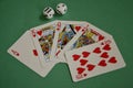 Fanned Out Red Hearts Poker Royal Flush and Dice on Green Baize Royalty Free Stock Photo