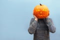 Fanny guy with pumpkin instead of head isolated on blue background, scary jack o lantern pumpkin for halloween