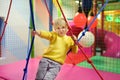 Fanny little boy after activity on trampoline. Child playing on indoor playground Royalty Free Stock Photo