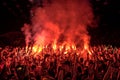 Fans burn red flares at rock concert. Cheering crowd at concert. Fire show. Royalty Free Stock Photo