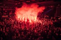 Fans burn red flares at rock concert. Cheering crowd at concert. Fire show. Royalty Free Stock Photo