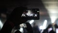 Fans hands recording video with smartphone at rock concert and beautiful bokeh