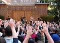 Fans raise hands at concert by They Might Be Giant