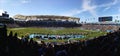 Fans watch NFL football game inside stadium Royalty Free Stock Photo