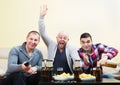 Fans watching hockey game heatedly Royalty Free Stock Photo