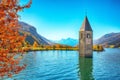 Fantasic autumn view of submerged bell tower in lake Resia