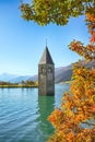 Fantasic autumn view of submerged bell tower in lake Resia