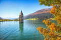 Fantasic autumn view of submerged bell tower in lake Resia