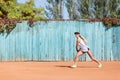 Sports girl playing badminton on the outdoors background. Active lifestyle concept. Copy space. Royalty Free Stock Photo