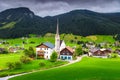 Spring alpine landscape with traditional houses and green fields, Austria Royalty Free Stock Photo