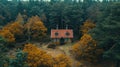 Fantastic autumn landscape with glowing wooden cabin in autumn forest. Cozy house in Carpathian mountains. Royalty Free Stock Photo