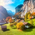 Fantastic autumn view of Lauterbrunnen village with awesome waterfall  Staubbach  in the background Royalty Free Stock Photo