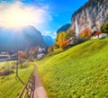 Fantastic autumn view of Lauterbrunnen village with awesome waterfall  Staubbach  in the background Royalty Free Stock Photo