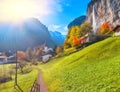 Fantastic autumn view of Lauterbrunnen village with awesome waterfall  Staubbach  in the background Royalty Free Stock Photo