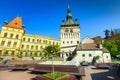 Fantastic clock tower building in the best touristic city, resting place with benches, Sighisoara, Transylvania, Romania, Europe Royalty Free Stock Photo