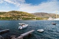 Fantastic croatian seascape with narrow wooden bridge and small boat at sunset. Dubrovnik, Croatia. Travel concept. Royalty Free Stock Photo