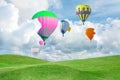 Fantastic dreams. Hot air balloons in sky with fluffy clouds over green meadow Royalty Free Stock Photo
