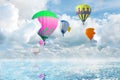 Fantastic dreams. Hot air balloons in sky with fluffy clouds over sea Royalty Free Stock Photo