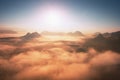 Fantastic dreamy sunrise on the top of the rocky mountain with the view into misty valley