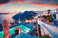 Fantastic evening view of Santorini island. Picturesque spring sunset on famous Greek resort Fira, Greece, Europe. Traveling Royalty Free Stock Photo