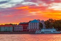 Fantastic fiery sunset over the Neva River. The building of St. Petersburg University