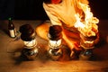 Fantastic fire flames, the old man with three vintage kerosene pressure lanterns on wooden at night, beautiful brightly burning Royalty Free Stock Photo