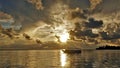 Fantastic golden sunset in the Maldives.The setting sun shines through the picturesque clouds