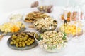 Fantastic grazing table. Cheese and salad dish, wine glass, olives, on table. Royalty Free Stock Photo