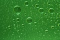 Fantastic green drops of water on glass Royalty Free Stock Photo