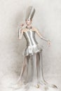 Fantastic image of beautiful young cosmic woman in foil dress and with metallic makeup