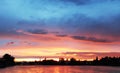 Fantastic landscape. The dramatic scene sunset over a lake, rays Royalty Free Stock Photo