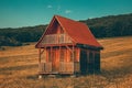 Fantastic landscape lonely wooden house in the mountains/hills with forest in background meadow hill with yellow house color gradi Royalty Free Stock Photo